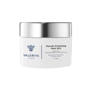 The image shows a jar of "Glycolic Exfoliating Pads 20%" from the brand Valeriya Life. The container has a white design with a silver lid, adding a sleek, modern touch. The label features product name, key ingredients and benefits in a modern, clean font. The jar is placed on a neutral, soft-colored background, highlighting the minimalist and professional look of the product.