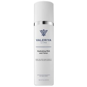 The image shows a bottle of "Hydrating Mist and Toner" from brand Valeriya Life has a sleek, white design. The bottle has a spray nozzle. The label includes product name and key product ingredients. The background is light and neutral, emphasizing the clean and minimalistic design of the packaging.
