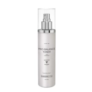 The image shows a bottle of "Pro Balance Toner" from the brand Valeriya Life, featuring a sleek, silver pump bottle with a clear cap. The label on the bottle displays the product name, key ingredients and benefits in a clean, modern font. The bottle is placed against a light-colored background, emphasizing its minimalist and elegant design. This toner is designed to balance the skin’s pH, refresh, and prepare the skin for further skincare treatments.