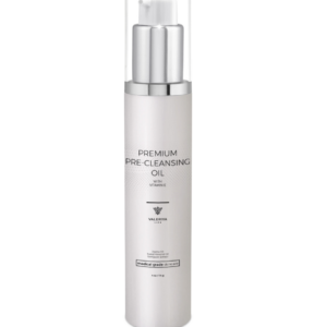 The image shows a bottle of "Premium Pre-Cleansing Oil" from the brand Valeriya Life, featuring a sleek, silver pump bottle with a clear cap. The label on the bottle displays the product name, key ingredients and benefits in a clean, modern font. The bottle is placed against a light-colored background, emphasizing its minimalist and elegant design. The oil is designed to gently remove makeup, sunscreen, and impurities, preparing the skin for the next steps in the skincare routine.