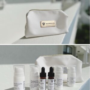 The image shows a luxurious beige cosmetic bag from the brand Valeriya Life with sample-sized skincare products, neatly organized in front of it. The background shows a background of a building with a similar color as the cosmetic bag. This kit includes various skincare items designed for a complete skincare routine.