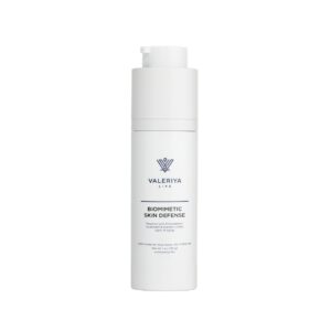 The image shows a bottle of "Biomimetic Skin Defense" from the brand Valeriya Life, featuring a sleek, white pump bottle. The label on the bottle displays the product name and key ingredients in a clean, modern font. The bottle is placed against a light-colored background, emphasizing its minimalist and elegant design.