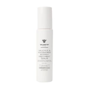 The image shows a bottle of "Salicylic Niacinamide Blemish Treatment Serum" from the brand Valeriya Life, featuring a sleek, white bottle. The label on the bottle displays the product name, key ingredients and benefits in a clean, modern font. The bottle is placed against a light-colored background, emphasizing its minimalist and elegant design.